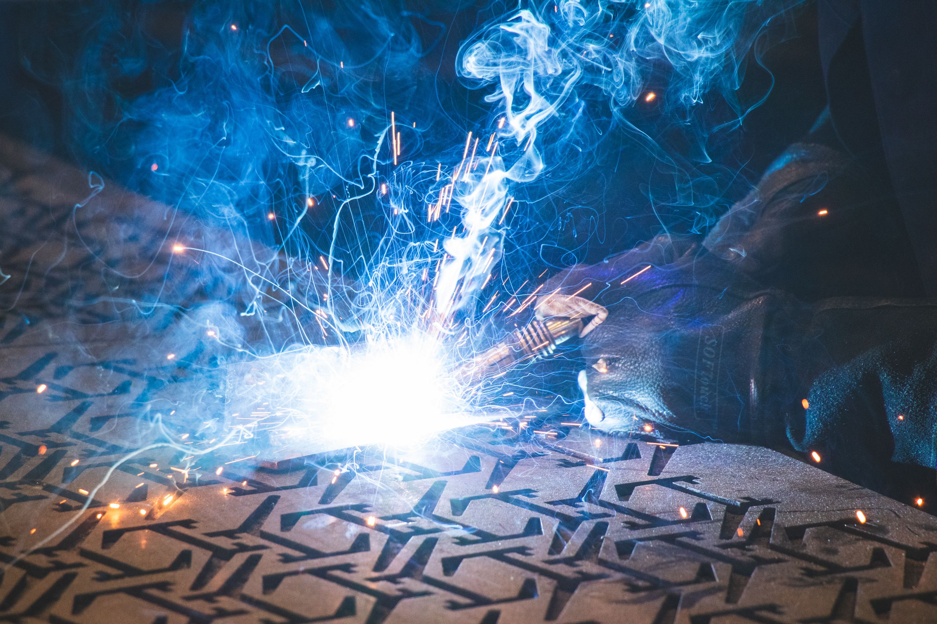 Close up of a welder welding on a metal sheet