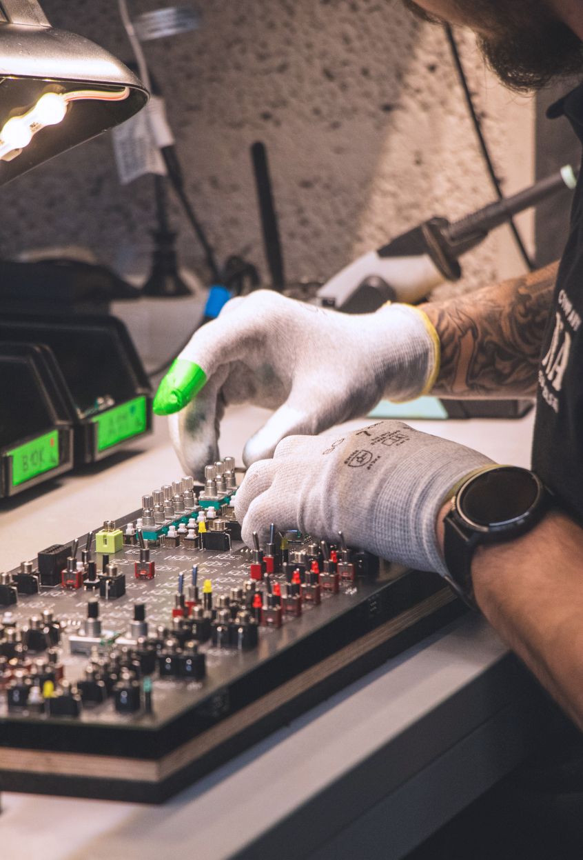 Two hands picking up electronic switches from a collection